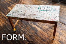 Load image into Gallery viewer, Artistic table with abstract designs on a wooden floor, featuring the word 'FORM.'