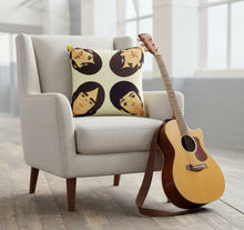 Load image into Gallery viewer, Beatles icon velvet cushion featuring the Fab Four by Stanley Chow for Reloved Design, plush scatter cushion handmade in Manchester displayed on a chair with a guitar
